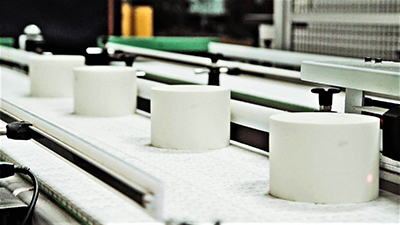 A conveyor belt filled with rolls of toilet paper 